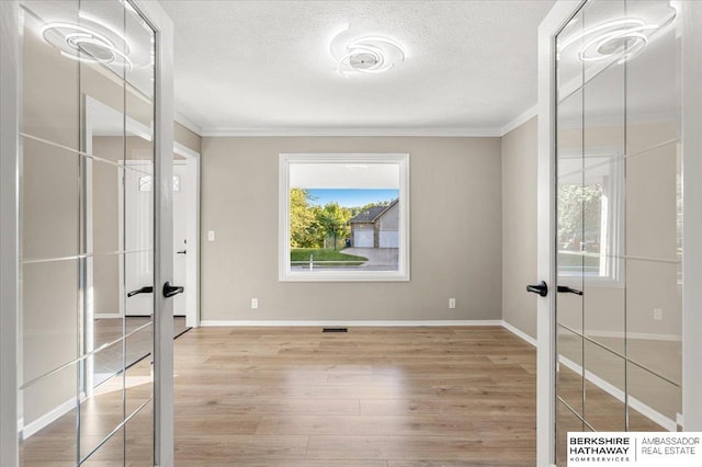 16324 Chicago St, Omaha, NE 68118 - unfurnished bedroom with french doors, crown molding, wood finished floors, a textured ceiling, and baseboards