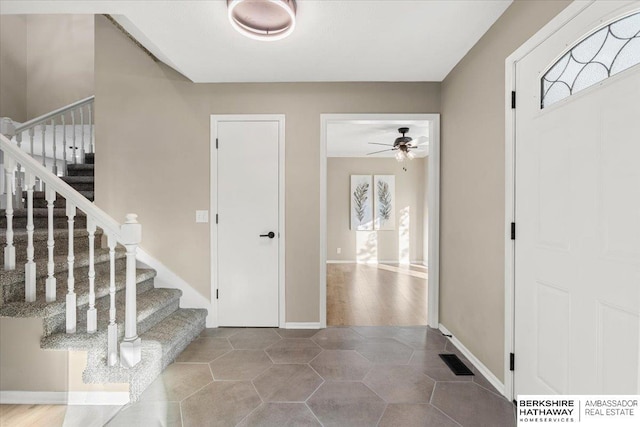 16324 Chicago St, Omaha, NE 68118 - foyer entrance with stairway, ceiling fan, and baseboards