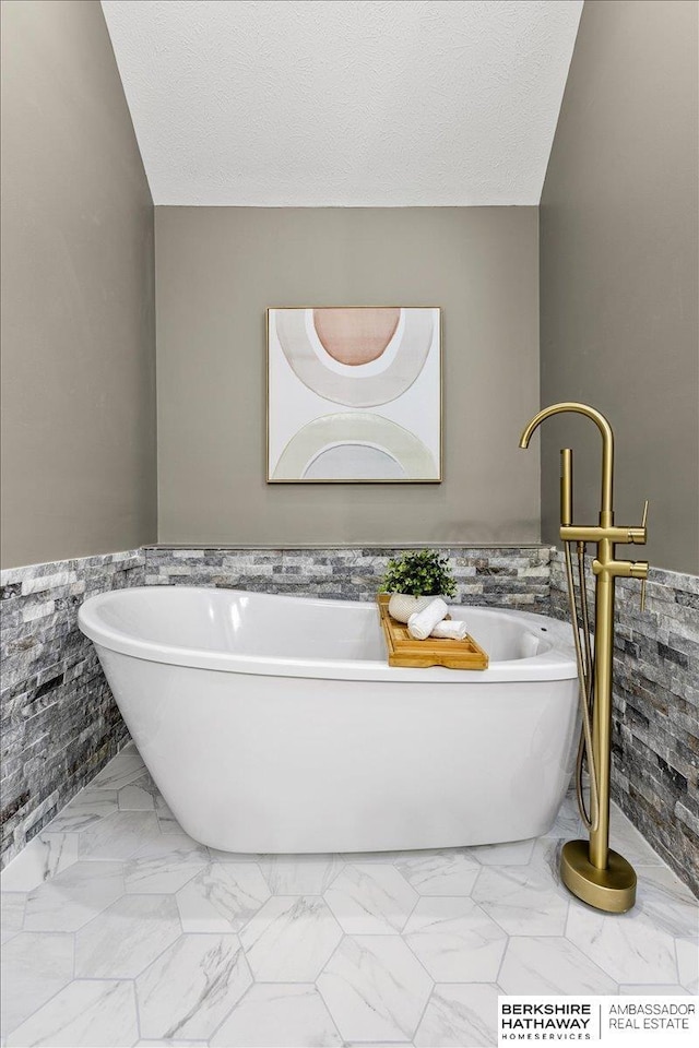 16324 Chicago St, Omaha, NE 68118 - bathroom with a wainscoted wall, a freestanding bath, and tile walls