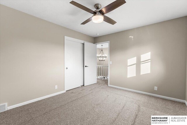 16324 Chicago St, Omaha, NE 68118 - unfurnished bedroom featuring carpet flooring, a chandelier, baseboards, and a closet