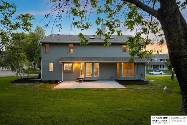 16324 Chicago St, Omaha, NE 68118 - back of property at dusk with a patio area and a lawn