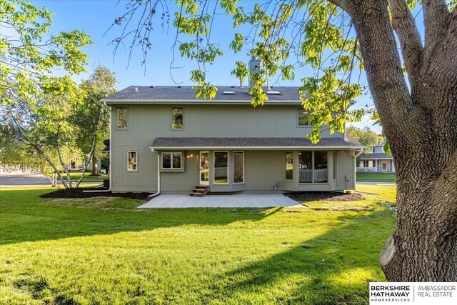 16324 Chicago St, Omaha, NE 68118 - back of property featuring a patio, a lawn, and entry steps
