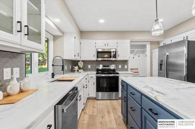 16324 Chicago St, Omaha, NE 68118 - kitchen featuring stainless steel appliances, a sink, white cabinetry, light stone countertops, and recessed lighting
