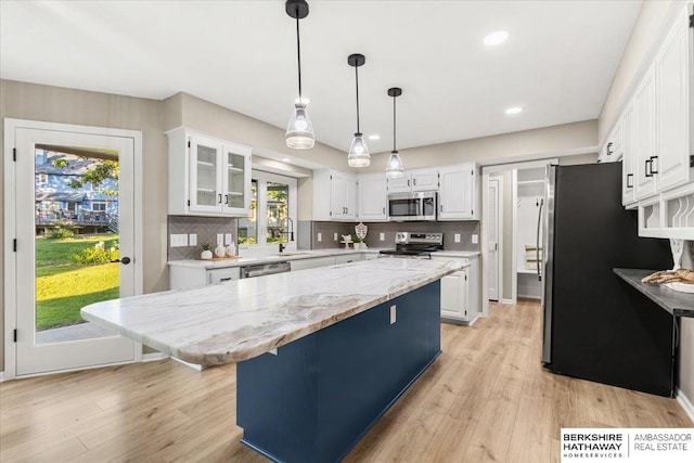 16324 Chicago St, Omaha, NE 68118 - kitchen with stainless steel appliances, white cabinetry, a kitchen island, and recessed lighting