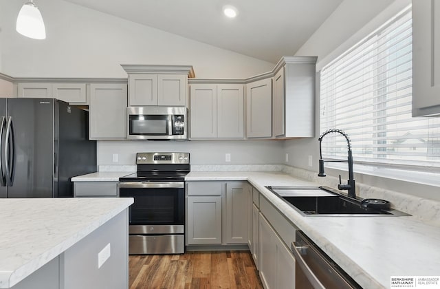 7164 N 167th St, Bennington, NE 68007 - kitchen with appliances with stainless steel finishes, gray cabinetry, a sink, vaulted ceiling, and light countertops