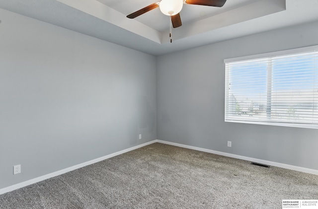 7164 N 167th St, Bennington, NE 68007 - carpeted empty room with a tray ceiling, ceiling fan, and baseboards