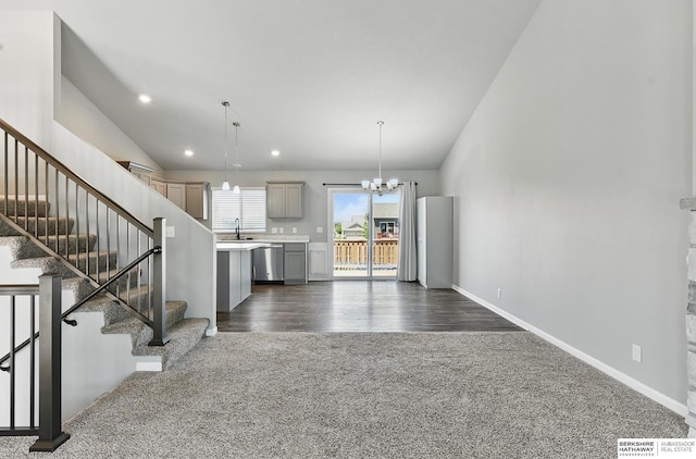7164 N 167th St, Bennington, NE 68007 - kitchen featuring stainless steel dishwasher, dark carpet, gray cabinets, a chandelier, and light countertops
