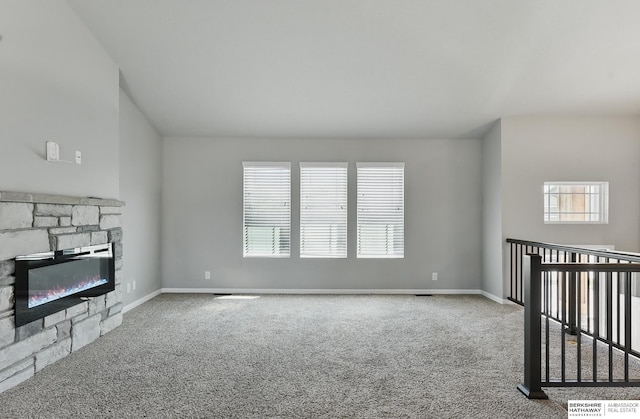7164 N 167th St, Bennington, NE 68007 - unfurnished living room with carpet, a stone fireplace, and baseboards