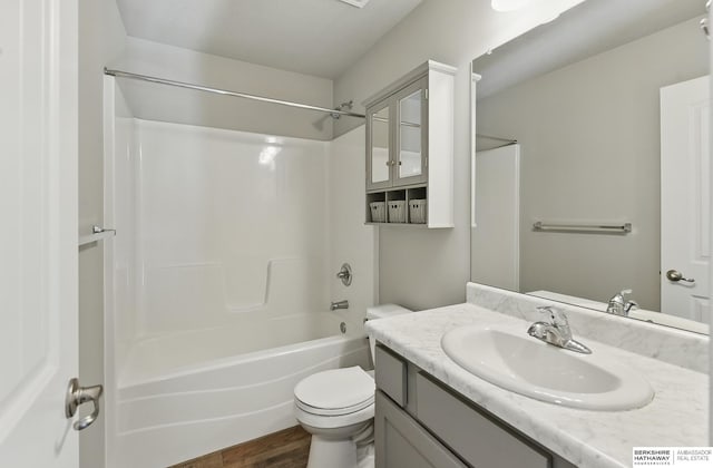 7164 N 167th St, Bennington, NE 68007 - bathroom with vanity, wood finished floors, shower / bath combination, and toilet