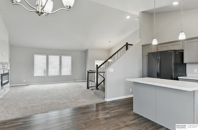 7164 N 167th St, Bennington, NE 68007 - unfurnished living room featuring a chandelier, stairs, baseboards, dark wood-style flooring, and recessed lighting