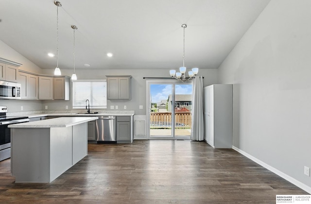 7164 N 167th St, Bennington, NE 68007 - kitchen with appliances with stainless steel finishes, lofted ceiling, gray cabinetry, a sink, and light countertops