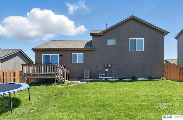 7164 N 167th St, Bennington, NE 68007 - rear view of house featuring a trampoline, a wooden deck, a shingled roof, and cooling unit