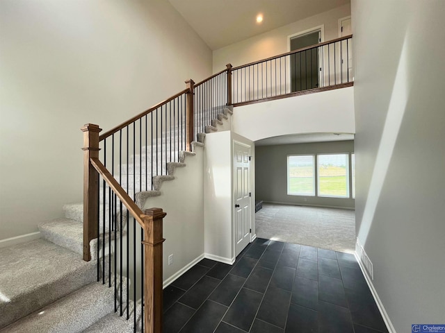 4618 N 212th St, Elkhorn, NE 68022 - stairway featuring carpet floors, arched walkways, baseboards, a towering ceiling, and recessed lighting