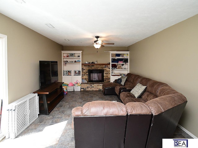 2103 Randall Dr, Bellevue, NE 68005 - living room featuring a ceiling fan, stone finish floors, a fireplace, and baseboards