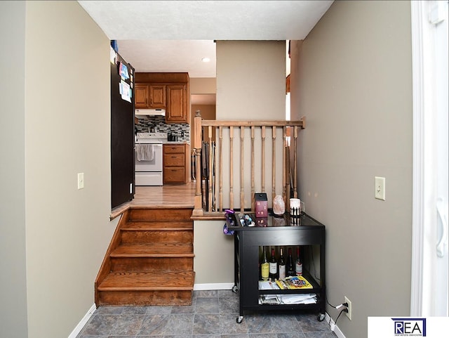 2103 Randall Dr, Bellevue, NE 68005 - staircase featuring baseboards and stone finish flooring