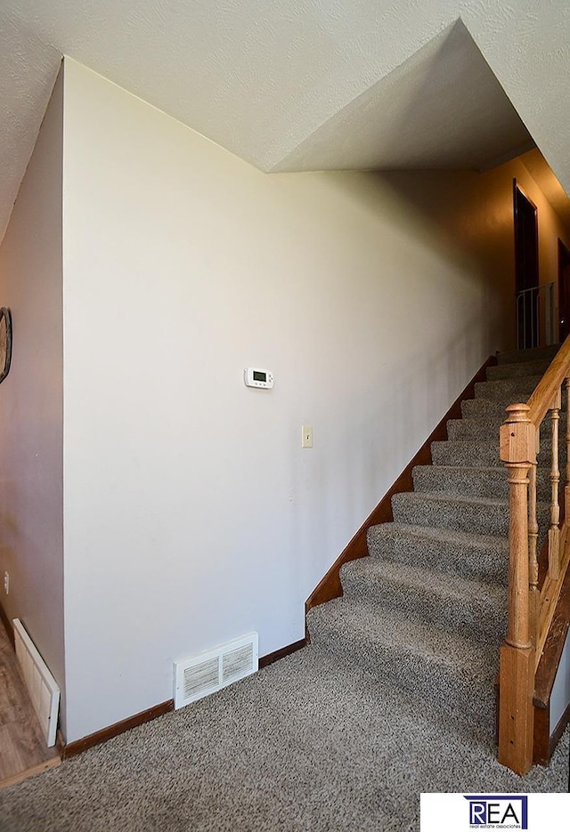 2103 Randall Dr, Bellevue, NE 68005 - staircase featuring baseboards and carpet flooring