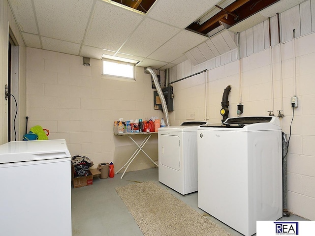 2103 Randall Dr, Bellevue, NE 68005 - laundry room featuring separate washer and dryer, concrete block wall, and electric panel