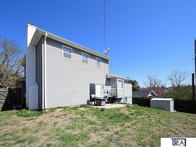 2103 Randall Dr, Bellevue, NE 68005 - back of house featuring a fenced backyard, a chimney, and a patio area
