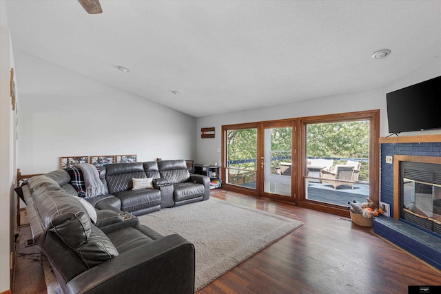 2706 Overlook Cir, Plattsmouth, NE 68048 - living area featuring wood finished floors, vaulted ceiling, and a brick fireplace