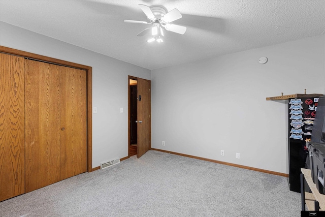 2706 Overlook Cir, Plattsmouth, NE 68048 - unfurnished bedroom with carpet flooring, ceiling fan, baseboards, and a textured ceiling