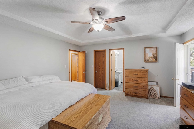 2706 Overlook Cir, Plattsmouth, NE 68048 - bedroom with a raised ceiling, light colored carpet, ensuite bath, a textured ceiling, and a ceiling fan