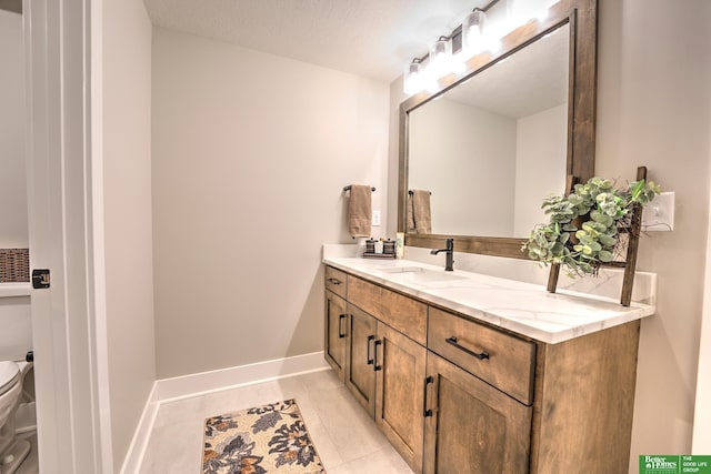 12369 Cooper St, Papillion, NE 68046 - full bathroom featuring double vanity, toilet, tile patterned floors, and baseboards