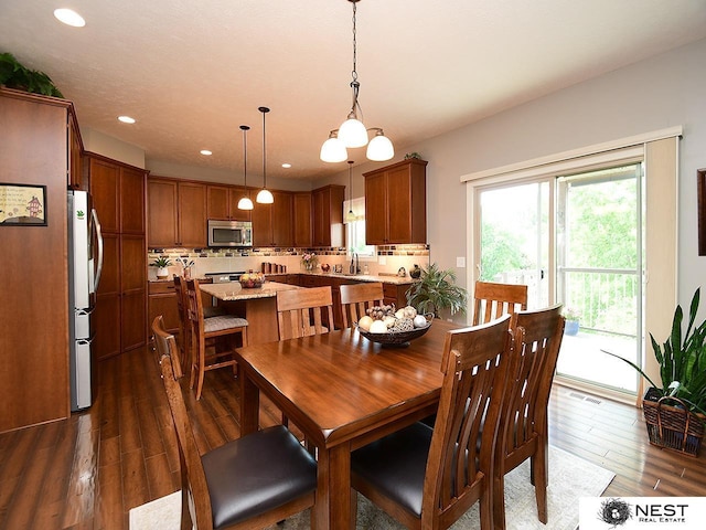 7521 Exbury Rd, Lincoln, NE 68516 - dining space featuring dark wood-style flooring and recessed lighting