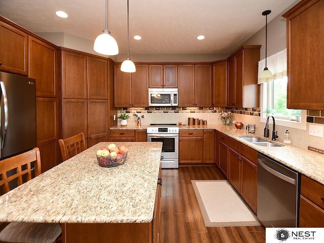 7521 Exbury Rd, Lincoln, NE 68516 - kitchen with stainless steel appliances, a sink, brown cabinets, dark wood-style floors, and tasteful backsplash