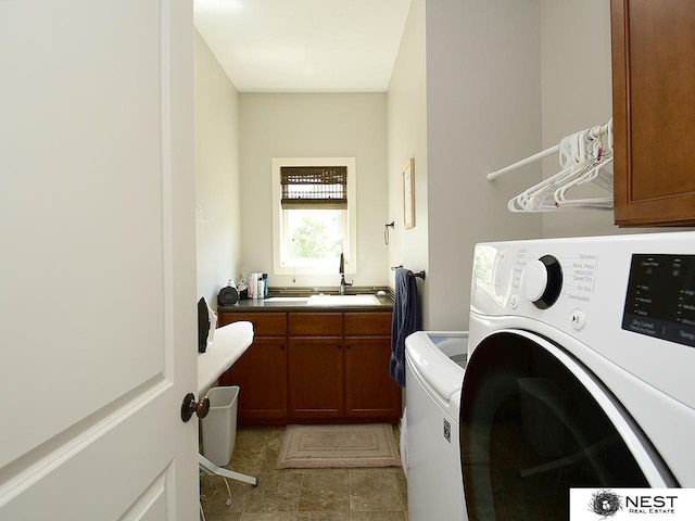 7521 Exbury Rd, Lincoln, NE 68516 - laundry room featuring cabinet space and washer and clothes dryer