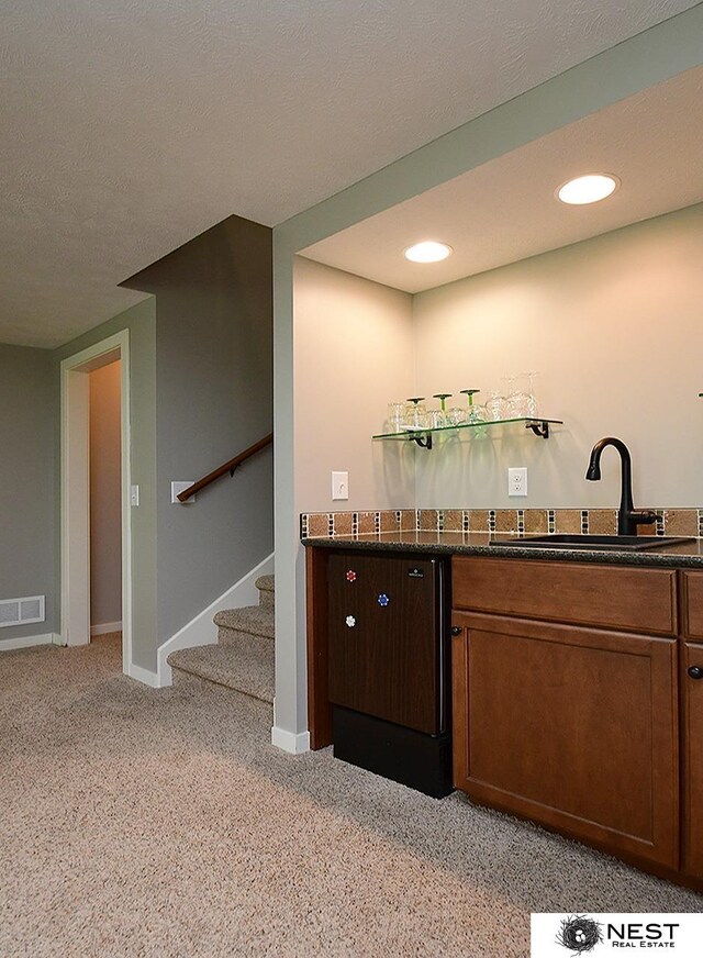 7521 Exbury Rd, Lincoln, NE 68516 - indoor bar featuring stairway, light carpet, baseboards, and recessed lighting