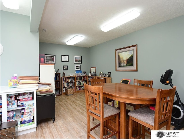 7521 Exbury Rd, Lincoln, NE 68516 - dining area featuring light wood-type flooring and a textured ceiling