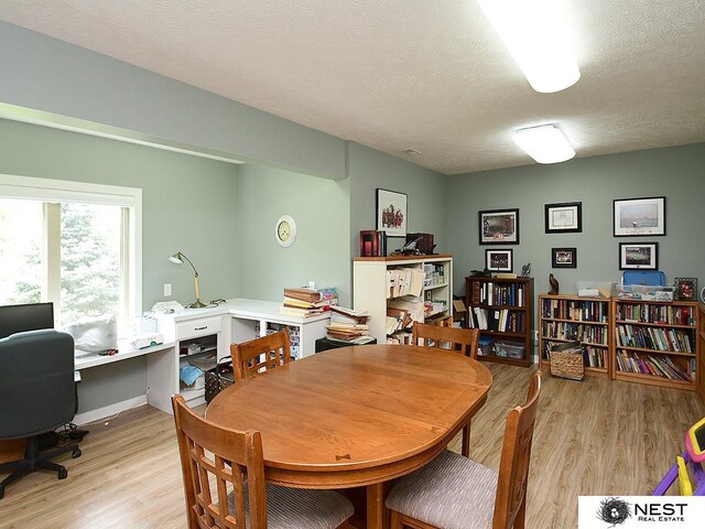 7521 Exbury Rd, Lincoln, NE 68516 - dining room featuring light wood-type flooring, a desk, and a textured ceiling