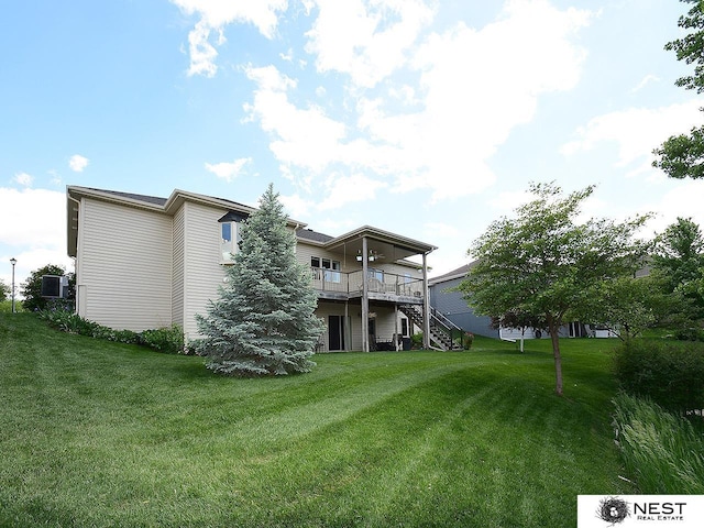 7521 Exbury Rd, Lincoln, NE 68516 - back of property with a yard, stairs, and a wooden deck