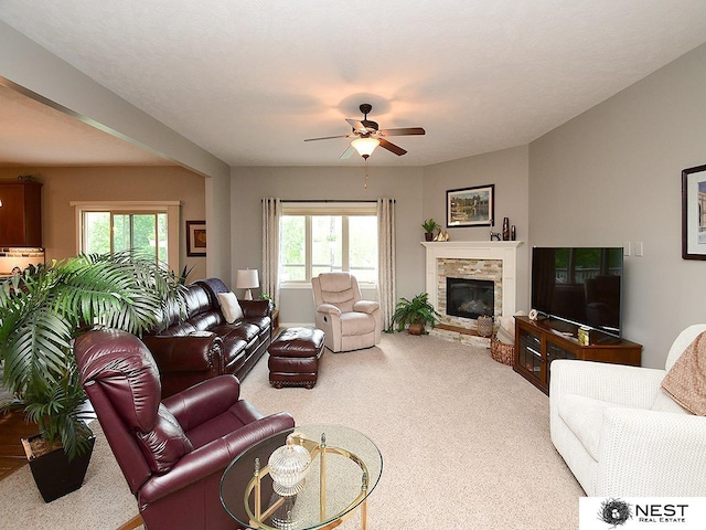 7521 Exbury Rd, Lincoln, NE 68516 - living area featuring carpet floors, ceiling fan, a fireplace, and plenty of natural light