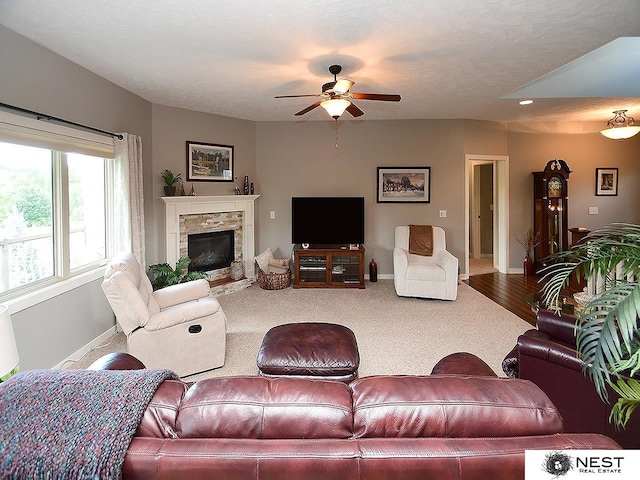 7521 Exbury Rd, Lincoln, NE 68516 - carpeted living area with ceiling fan, a fireplace, and baseboards