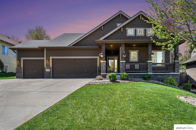 19349 I St, Omaha, NE 68135 - craftsman-style home with a garage, a front lawn, stone siding, and driveway