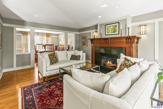 9826 Harney Pkwy N, Omaha, NE 68114 - living room with wood finished floors, baseboards, a premium fireplace, and recessed lighting