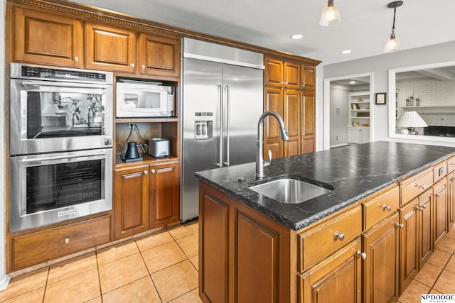 9826 Harney Pkwy N, Omaha, NE 68114 - kitchen with built in appliances, a sink, light tile patterned floors, brown cabinets, and recessed lighting