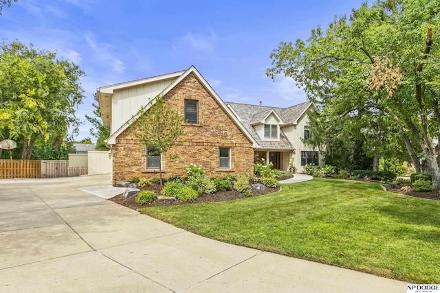 9826 Harney Pkwy N, Omaha, NE 68114 - view of front of home featuring brick siding, driveway, and board and batten siding