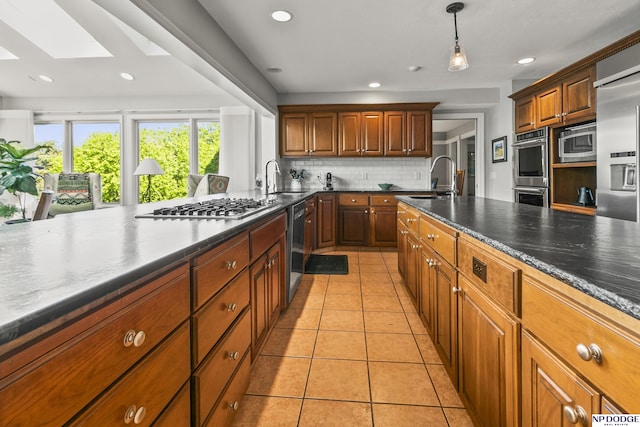 9826 Harney Pkwy N, Omaha, NE 68114 - kitchen with a sink, appliances with stainless steel finishes, decorative backsplash, light tile patterned floors, and recessed lighting