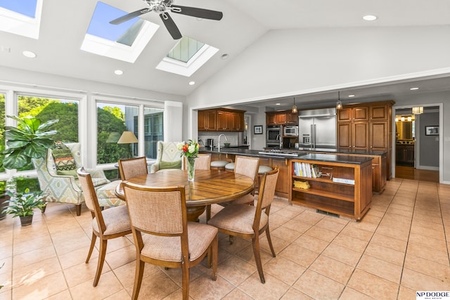9826 Harney Pkwy N, Omaha, NE 68114 - dining room featuring a skylight, light tile patterned floors, high vaulted ceiling, a ceiling fan, and recessed lighting