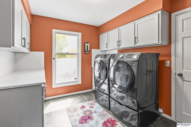 9826 Harney Pkwy N, Omaha, NE 68114 - laundry area featuring cabinet space, washer and clothes dryer, and baseboards