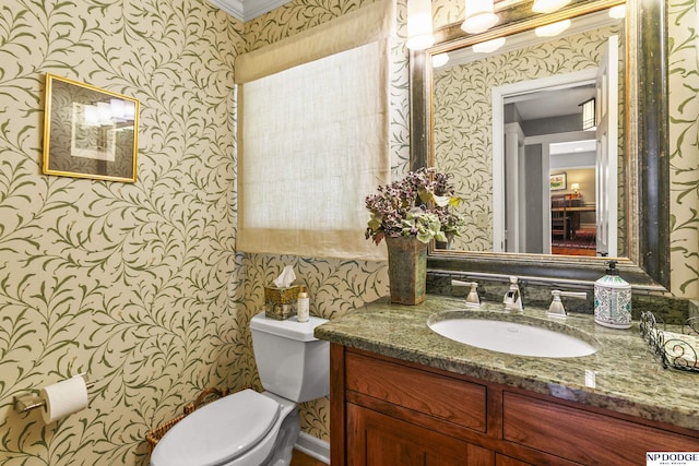 9826 Harney Pkwy N, Omaha, NE 68114 - half bathroom with wallpapered walls, toilet, vanity, and ornamental molding