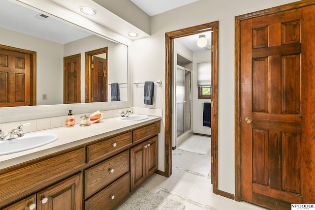 9826 Harney Pkwy N, Omaha, NE 68114 - full bath with double vanity, a shower stall, tile patterned floors, and baseboards