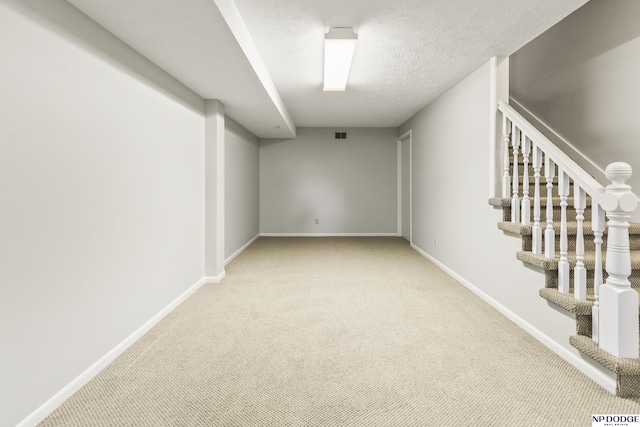 9826 Harney Pkwy N, Omaha, NE 68114 - finished basement featuring carpet floors, baseboards, stairway, and a textured ceiling
