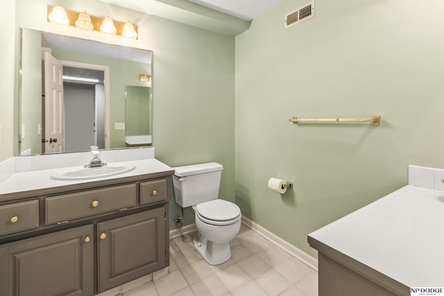 9826 Harney Pkwy N, Omaha, NE 68114 - bathroom featuring vanity, toilet, baseboards, and tile patterned floors