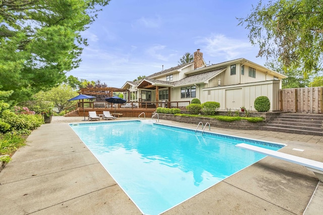 9826 Harney Pkwy N, Omaha, NE 68114 - view of swimming pool with a wooden deck, a diving board, stairway, and a patio area