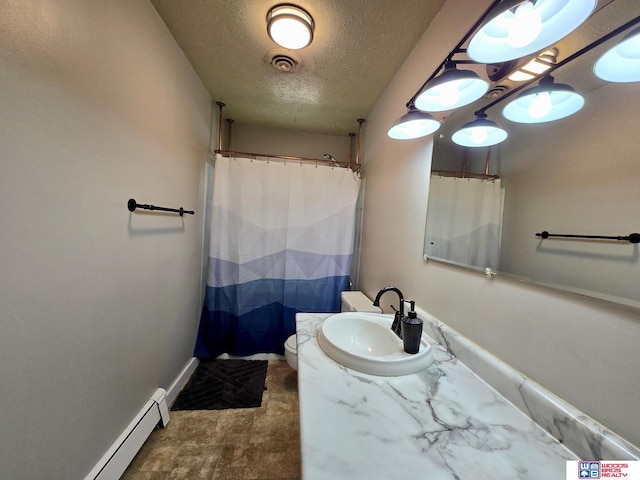 1241 Bessie St, Goehner, NE 68364 - full bathroom featuring a textured ceiling, vanity, toilet, a baseboard heating unit, and baseboards
