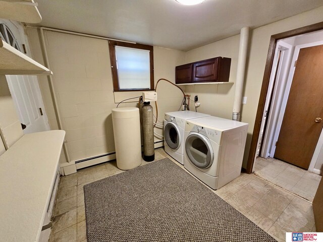 1241 Bessie St, Goehner, NE 68364 - laundry area with washer and dryer, cabinet space, a baseboard radiator, concrete block wall, and light tile patterned flooring