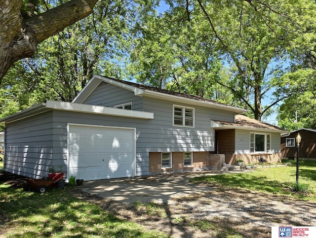 1241 Bessie St, Goehner, NE 68364 - tri-level home featuring a garage, driveway, and a front lawn
